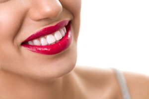 Closeup of woman's smile with lipstick