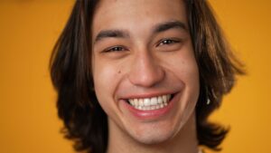 Smiling young man on orange